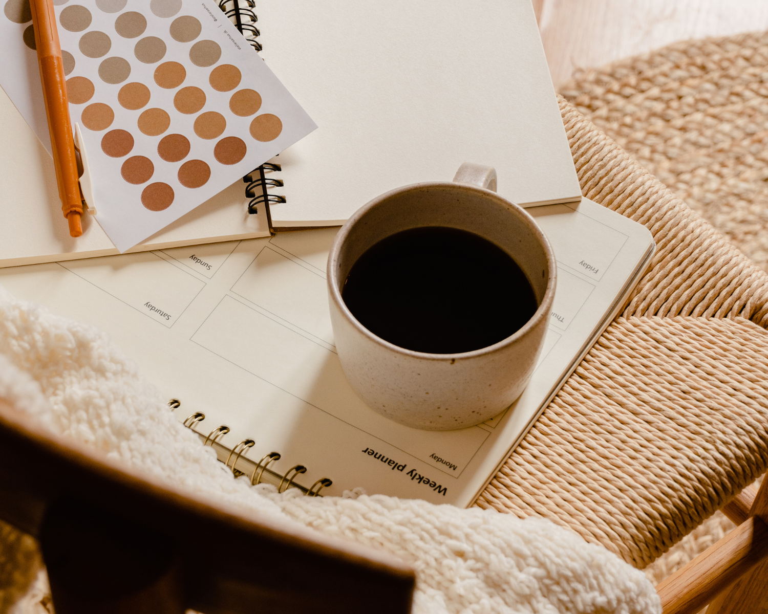 Your Legal Requirements as an affiliate or influencer - cup of coffee sitting on a chair, with a blank notebook